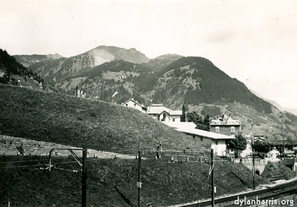 image: Photo: Looking East from Airolo. Shewing the Railway just about to enter the Southern end of the Gotthard Tunnel.